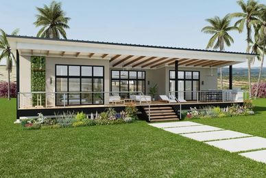 Casa moderna con terraza y jardín verde.